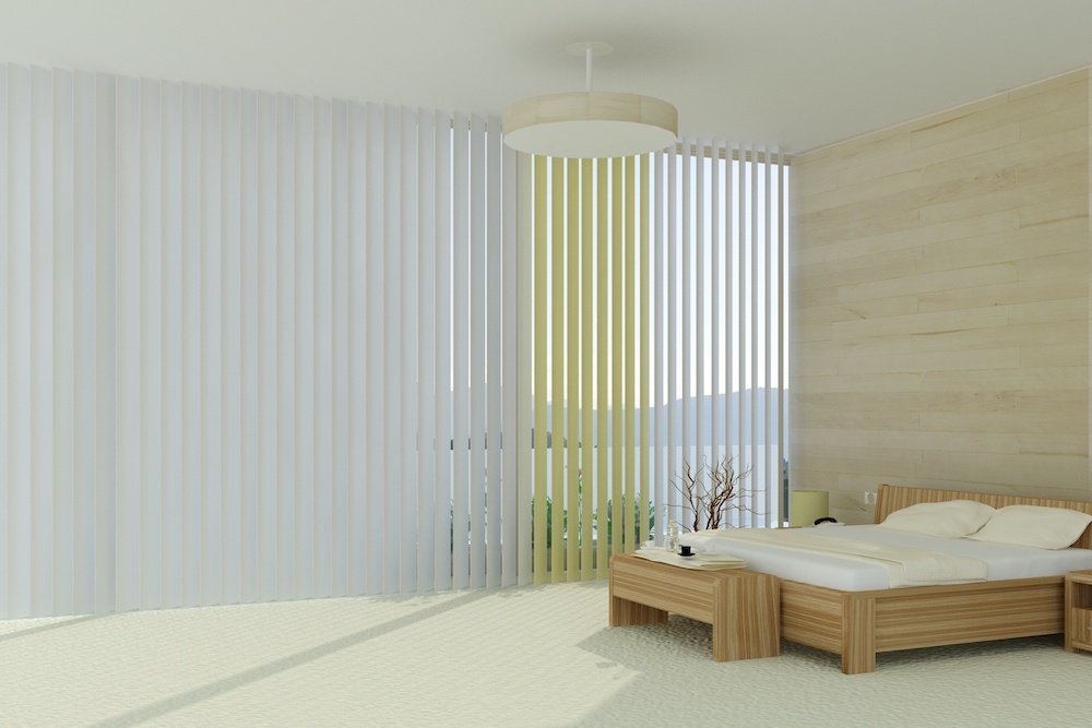 Clean vertical blinds in a white bedroom with an oak bed frame and mattress