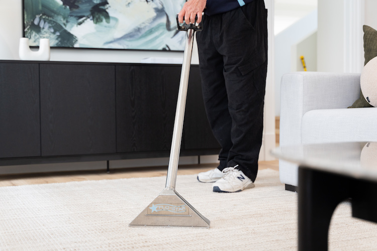 Charles cleaning a carpet in a Pert home